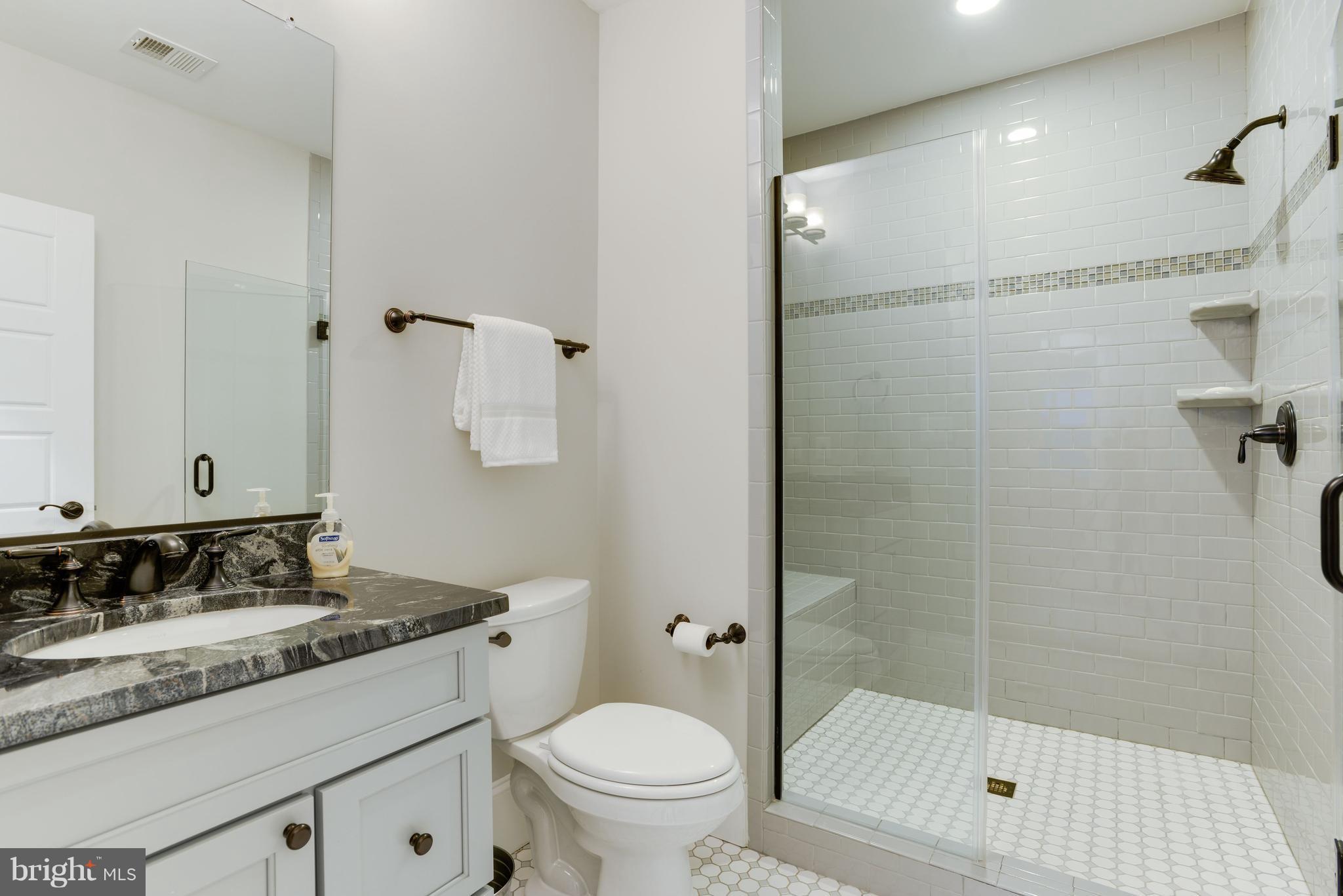 5836 MacArthur Boulevard Northwest Washington, DC 20016 - Photo 24 of 29 a bathroom with a granite countertop sink toilet and shower