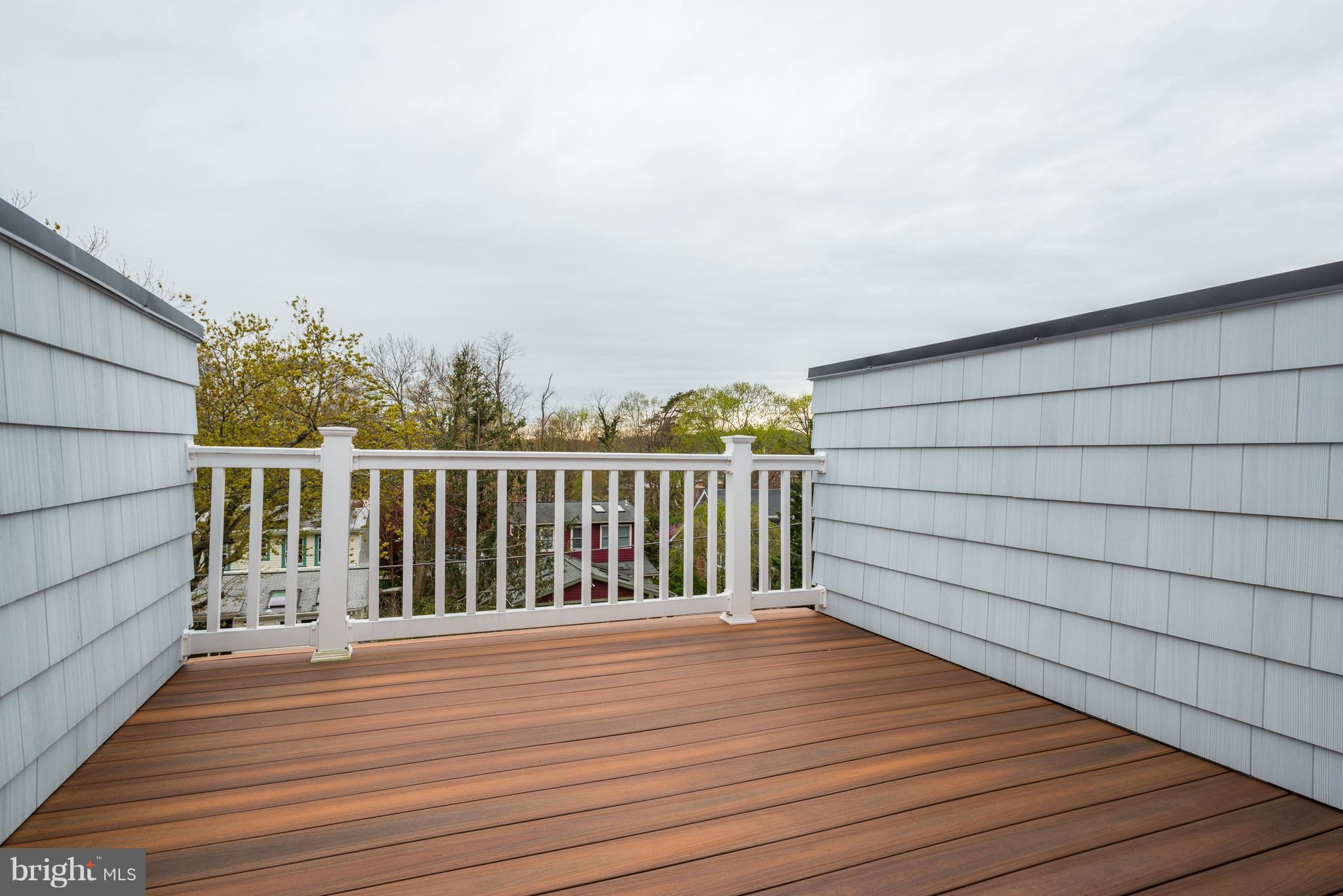 5836 MacArthur Boulevard Northwest Washington, DC 20016 - Photo 26 of 29 a view of a balcony with wooden floor and fence