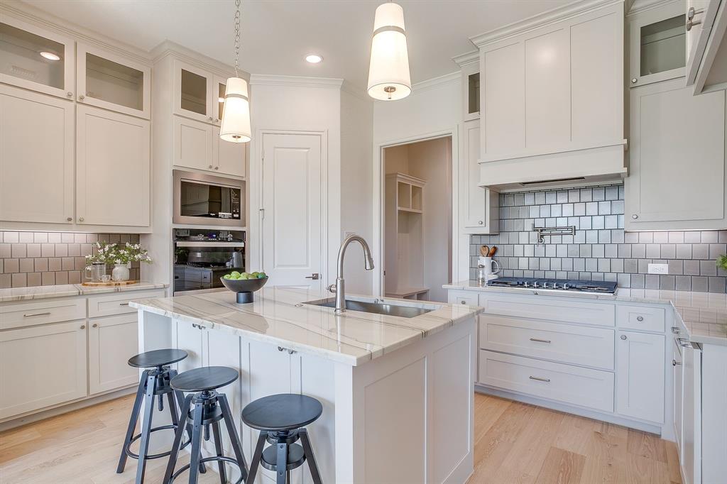 324 Slimp Bluff Azle, TX 76020 - Photo 11 of 35 a kitchen with stainless steel appliances granite countertop a sink and cabinets