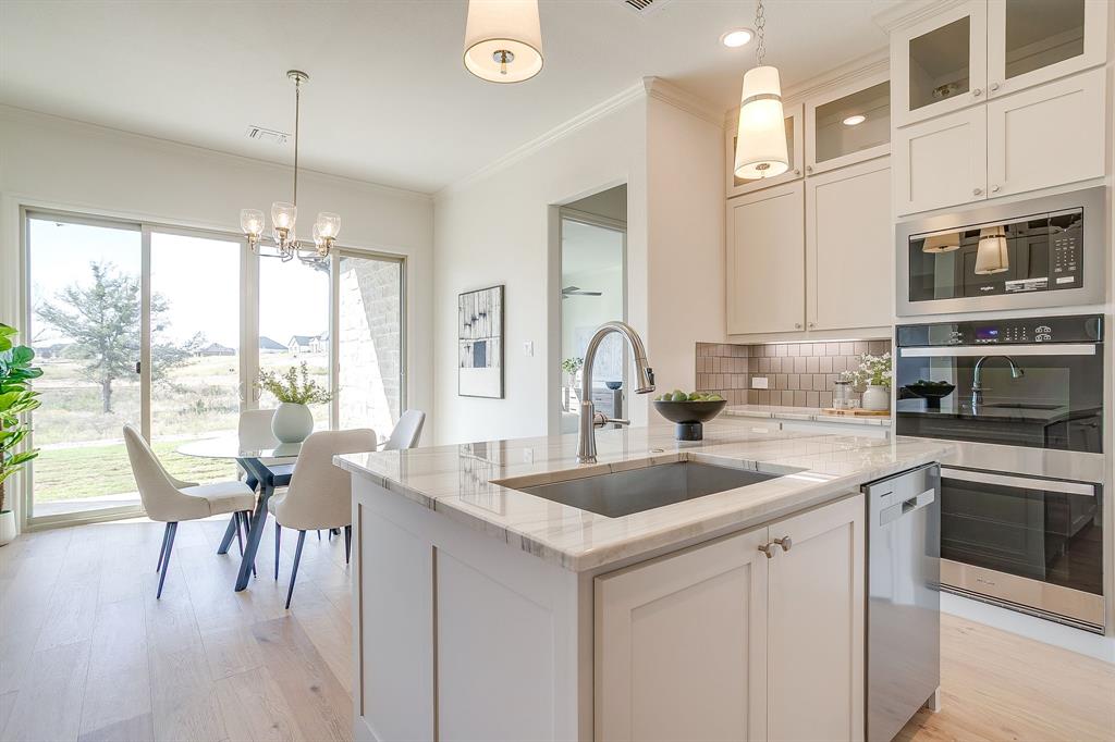 324 Slimp Bluff Azle, TX 76020 - Photo 12 of 35 a kitchen with stainless steel appliances granite countertop a stove a sink and white cabinets