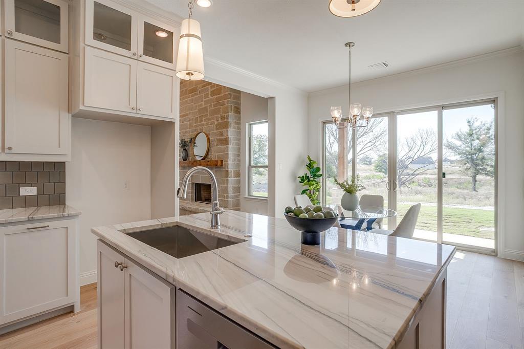 324 Slimp Bluff Azle, TX 76020 - Photo 13 of 35 a kitchen with a table chairs and wooden floor