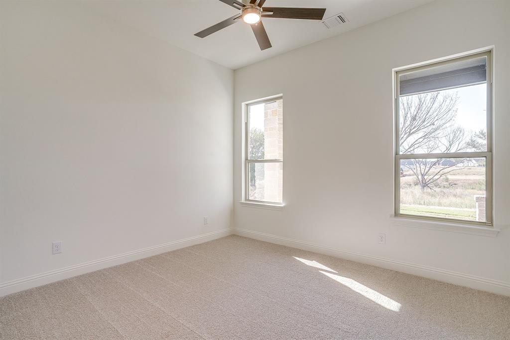 324 Slimp Bluff Azle, TX 76020 - Photo 25 of 35 an empty room with a window and a fan