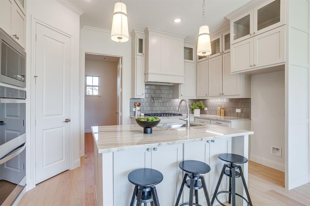 324 Slimp Bluff Azle, TX 76020 - Photo 10 of 35 a kitchen with stainless steel appliances a dining table chairs sink and cabinets