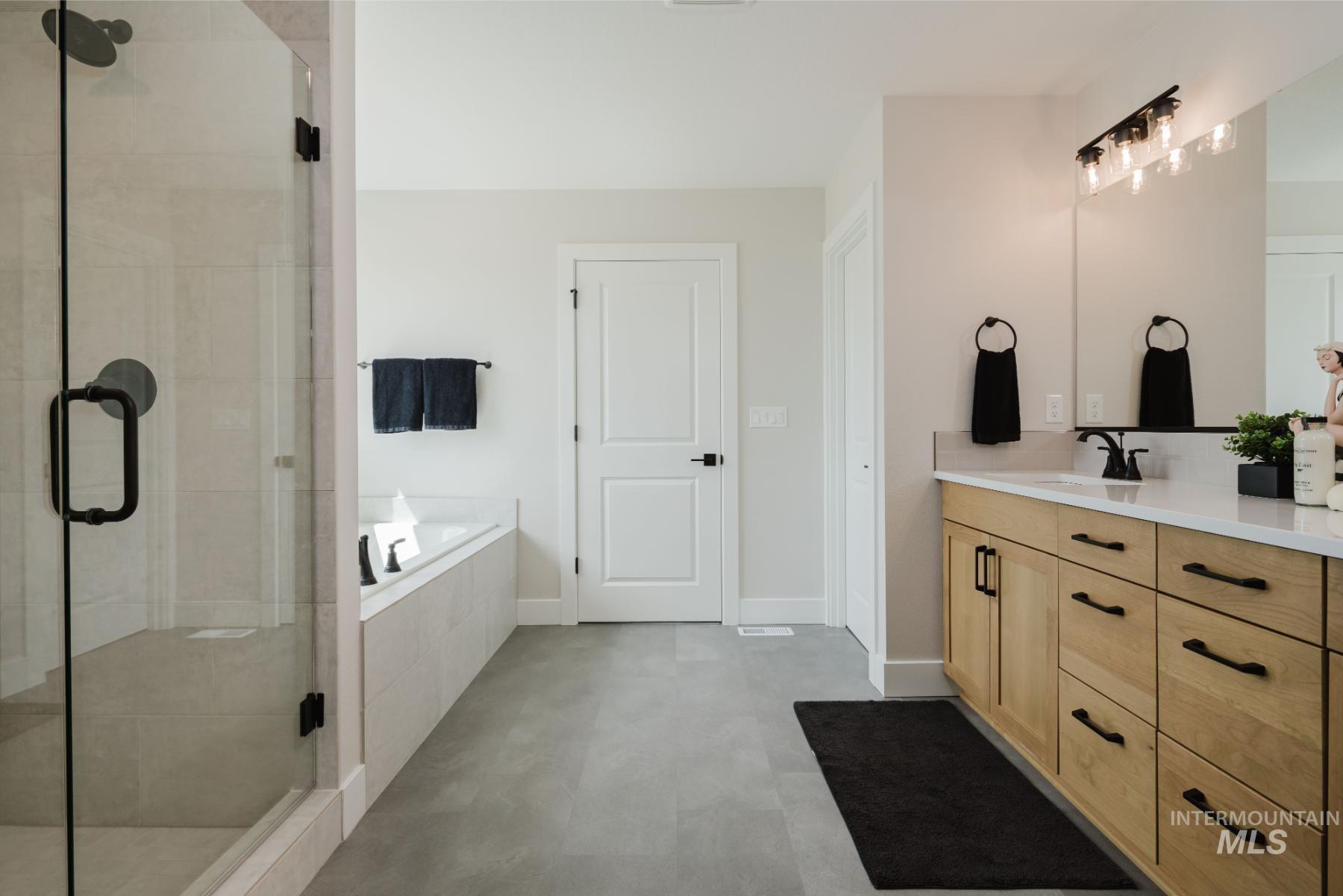 2866 North Stone Mill Avenue, Unit ROUGE Eagle, ID 83616 - Photo 15 of 18 Full bathroom featuring a bath, vanity, and a stall shower