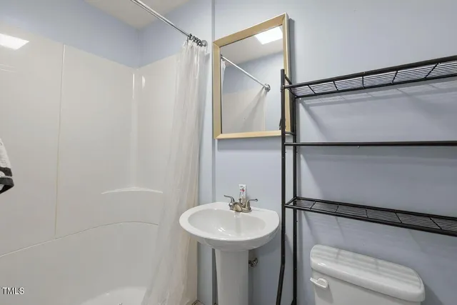 a view of a room with wooden floor and windows