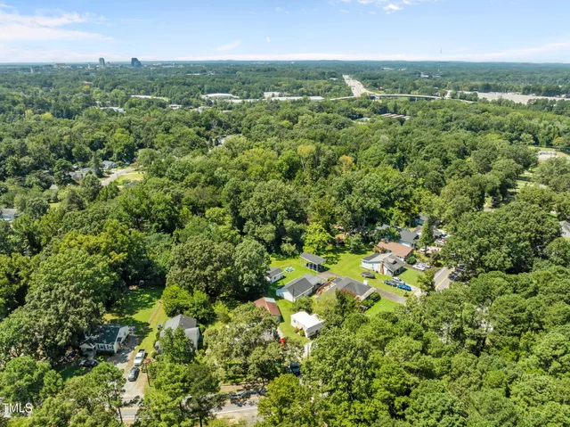 an aerial view of residential houses with outdoor and green space
