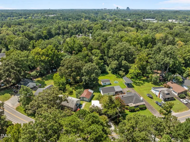 an aerial view of house with yard and swimming pool