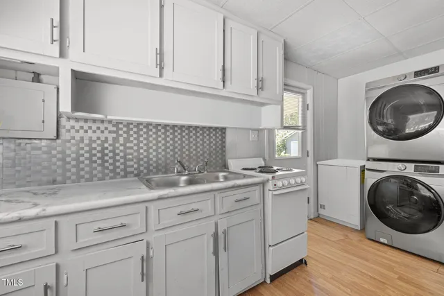 a kitchen with sink cabinets and washer