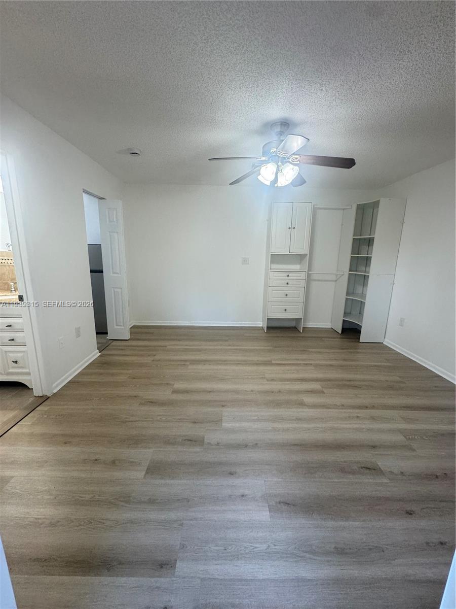 12828 Southwest 267th Street, Unit 1 Homestead, FL 33032 - Photo 3 of 7 a view of empty room with wooden floor and fan