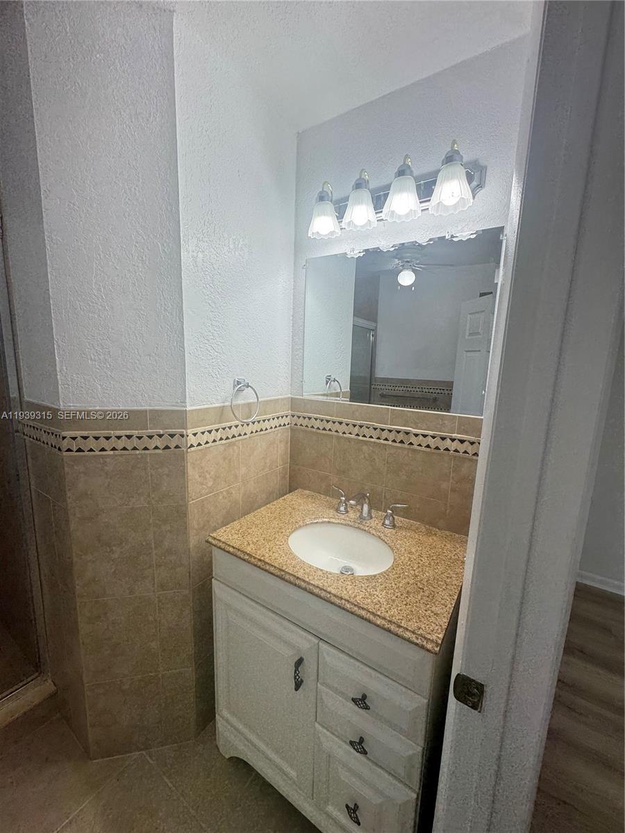 12828 Southwest 267th Street, Unit 1 Homestead, FL 33032 - Photo 7 of 7 a bathroom with a sink and a mirror