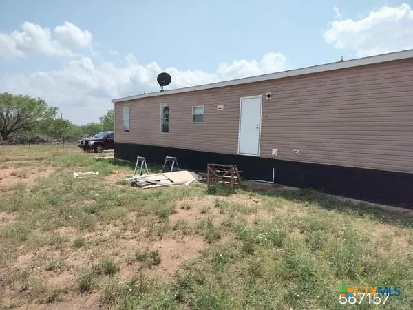 a front view of house with yard and car parked