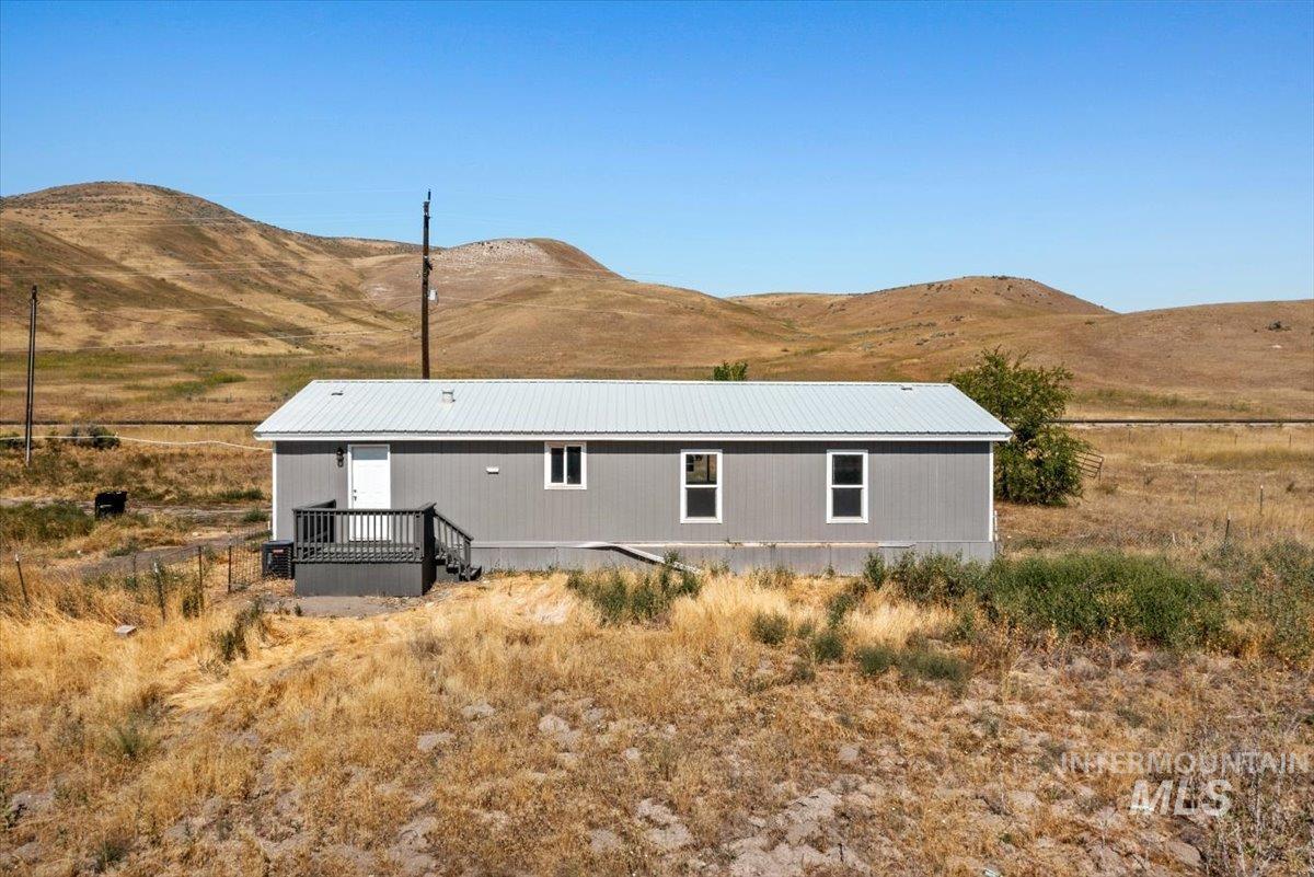 840 Highway 95 Weiser, ID 83672 - Photo 5 of 33 Rear view of house featuring a mountain view and a metal roof