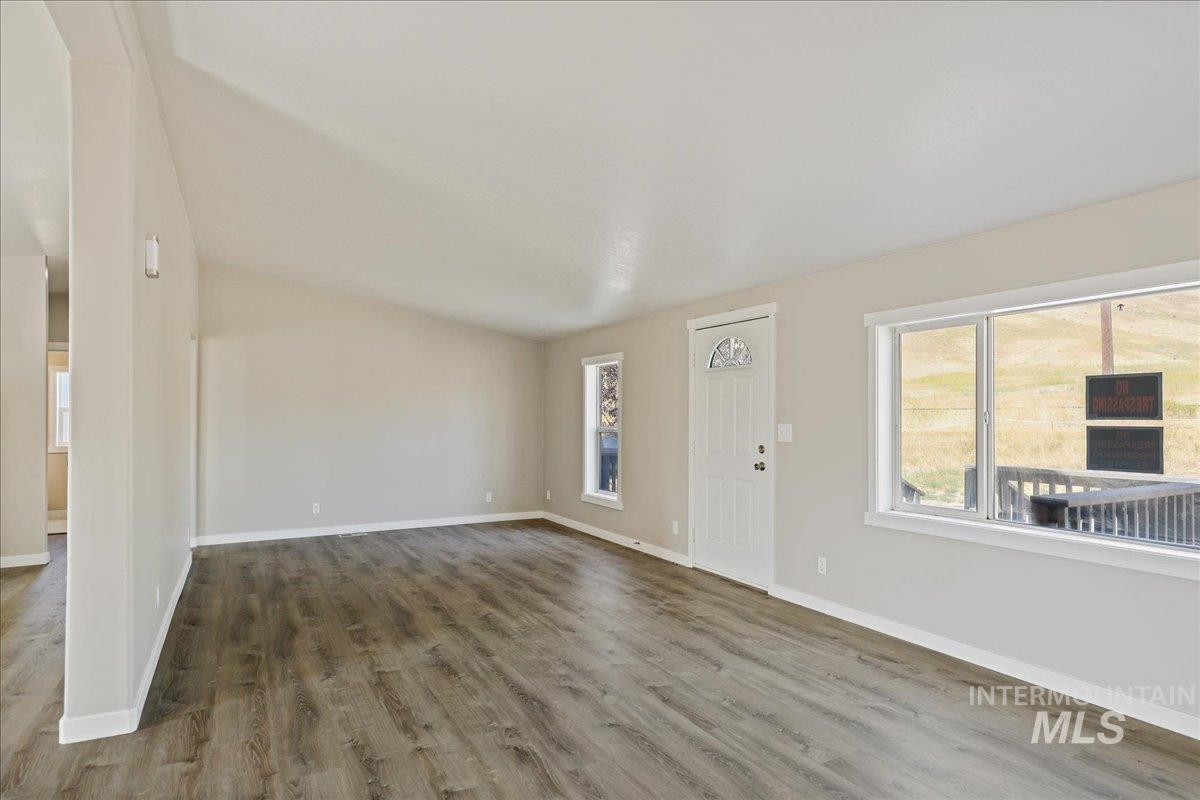 840 Highway 95 Weiser, ID 83672 - Photo 7 of 33 Unfurnished living room with wood finished floors and baseboards