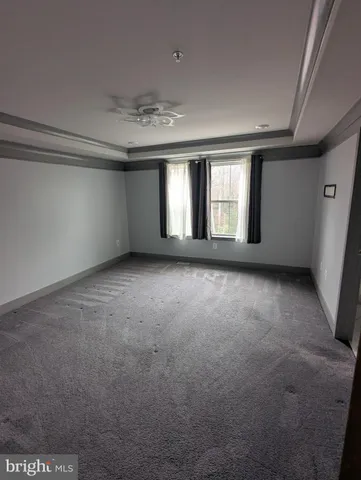 a bathroom with a granite countertop bathtub shower sink vanity and toilet