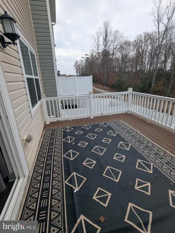 a balcony with wooden floor and fence