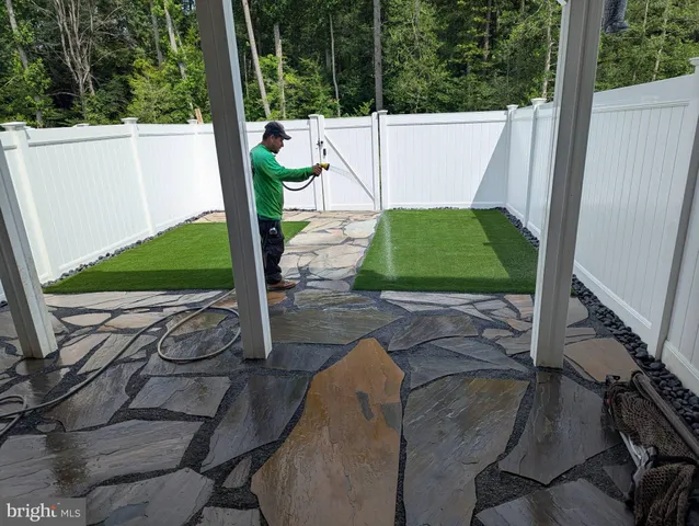 a backyard of a house with wooden floor and fence