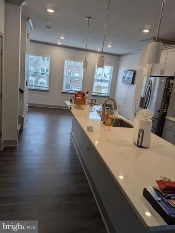 a large kitchen with stainless steel appliances a large counter top