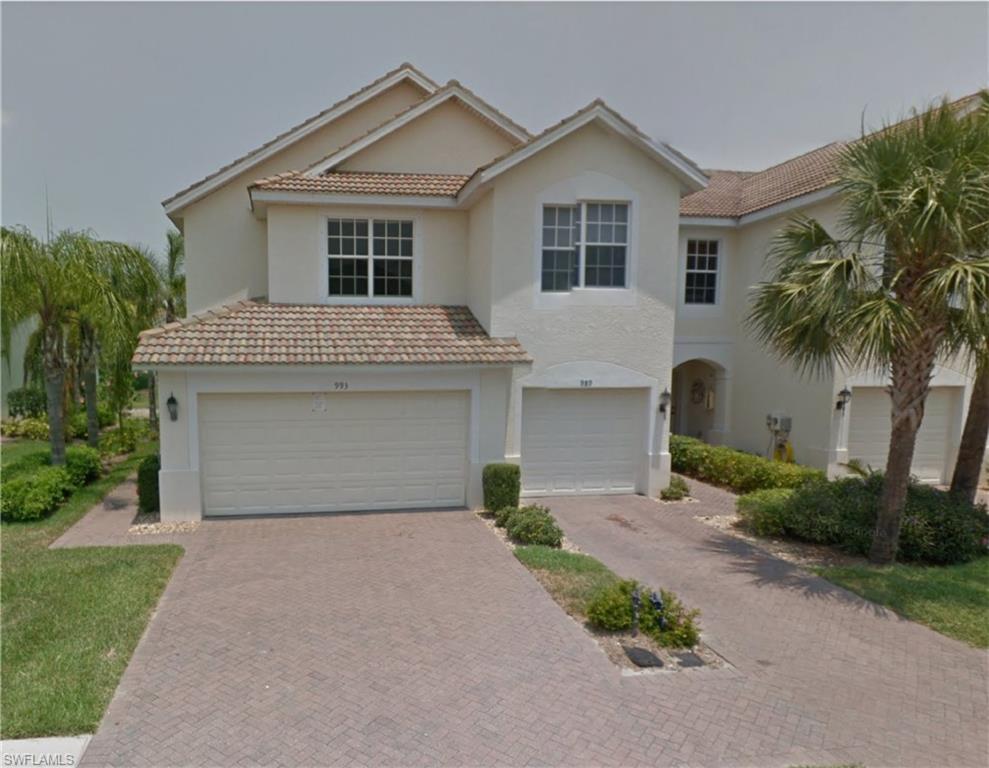 a front view of house with yard and trees around
