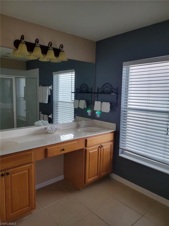 993 Hampton Circle, Unit 122 Naples, FL 34105 - Photo 14 of 26 a kitchen with stainless steel appliances granite countertop a sink and a wooden cabinets