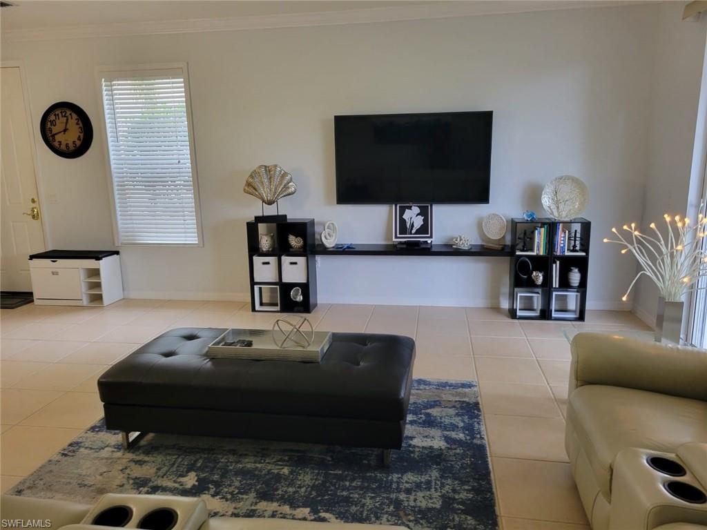 993 Hampton Circle, Unit 122 Naples, FL 34105 - Photo 9 of 26 a living room with furniture and a flat screen tv