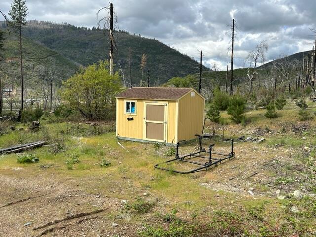 15923 Log Cabin Road French Gulch, CA 96033 - Photo 7 of 24 a backyard of a house with table and chairs