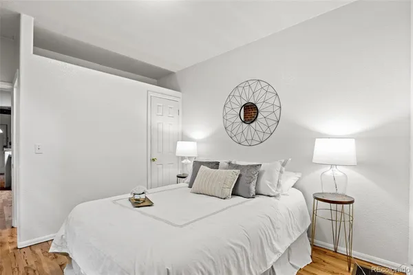 a bedroom with bed and a mirror