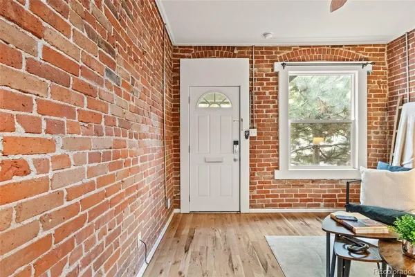 a view of a bedroom with wooden floor and a window