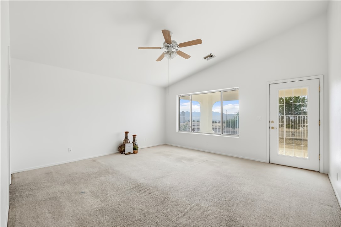 2853 Winchester Road Bullhead City, AZ 86442 - Photo 24 of 40 Spacious interior featuring a vaulted ceiling and a ceiling fan with wood-finish blades