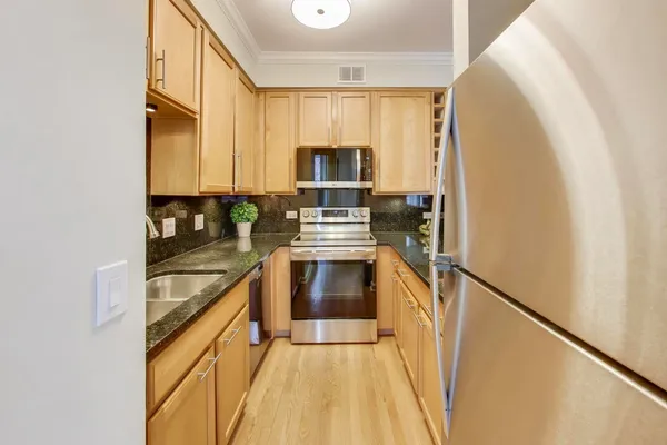 a kitchen with a sink and a refrigerator