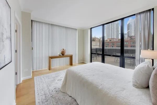 a bedroom with a large bed and a large window