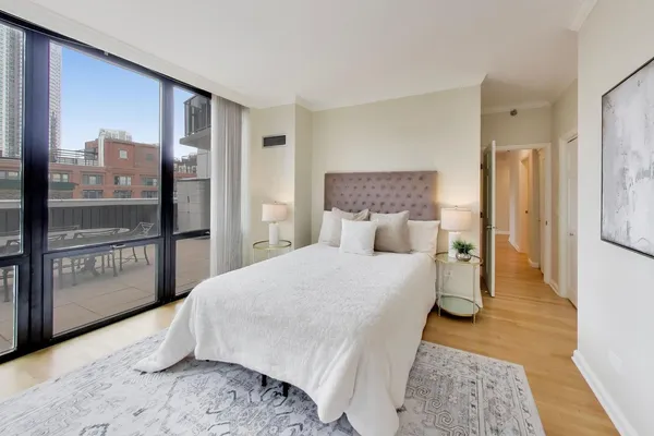 a bed room with a bed and a large window