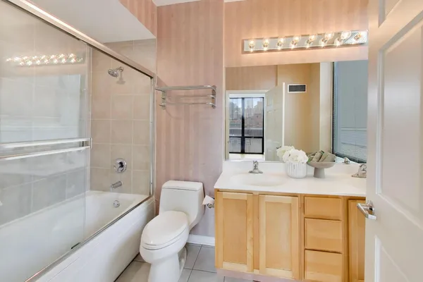 a bathroom with a granite countertop sink toilet and shower