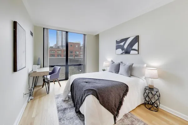 a bedroom with a bed and a table