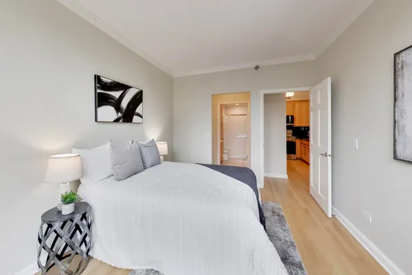 a bedroom with a bed and a painting on the wall