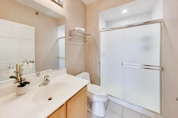 a bathroom with a sink toilet and shower