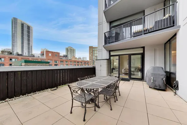 a view of a patio with a table and chairs