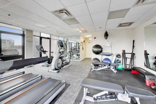 a room with gym equipment and a large window