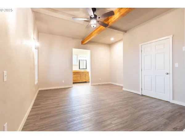 a view of an empty room and wooden floor