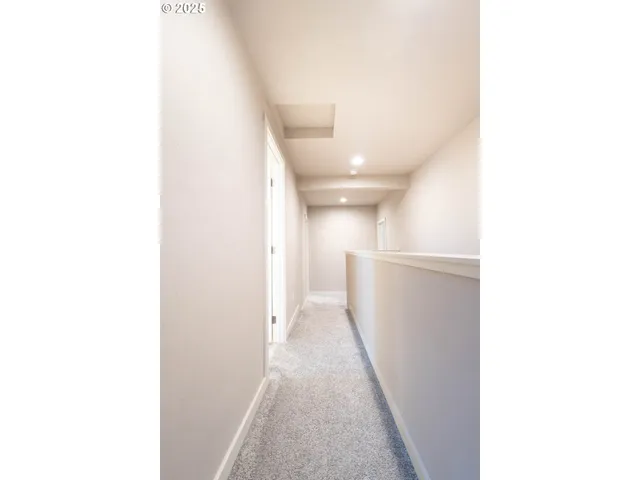a view of a hallway with white walls