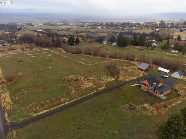 an aerial view of a house with a yard