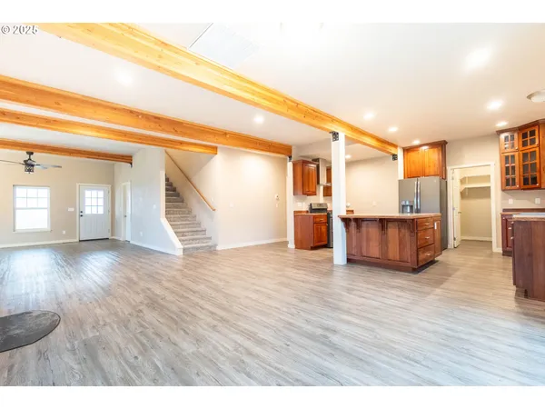 a view of a room with wooden floor