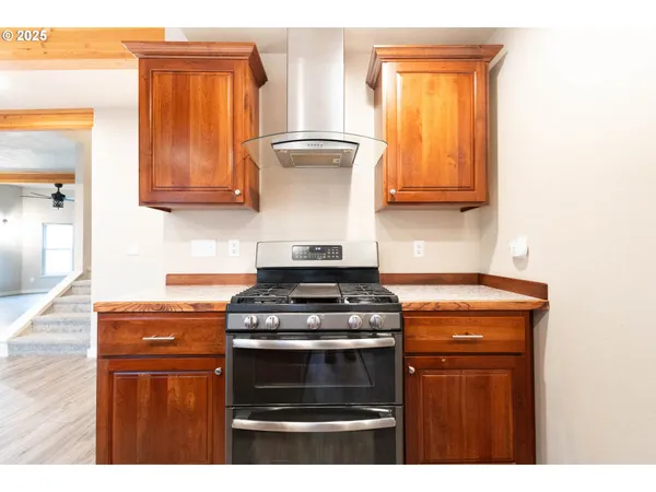 a kitchen with granite countertop a stove top oven