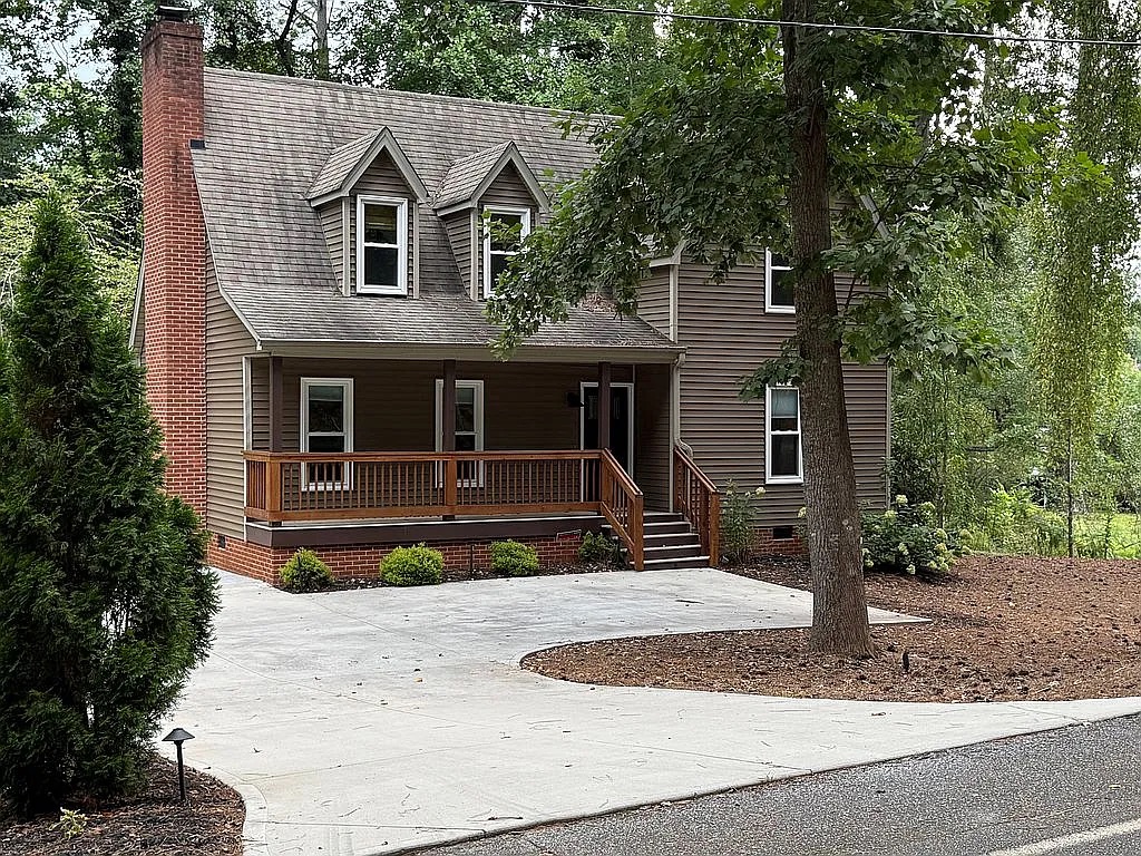 315 Rock Creek Road Clemson, SC 29631 - Photo 1 of 18 A spacious concrete driveway leads toward the classic covered porch and brick chimney.