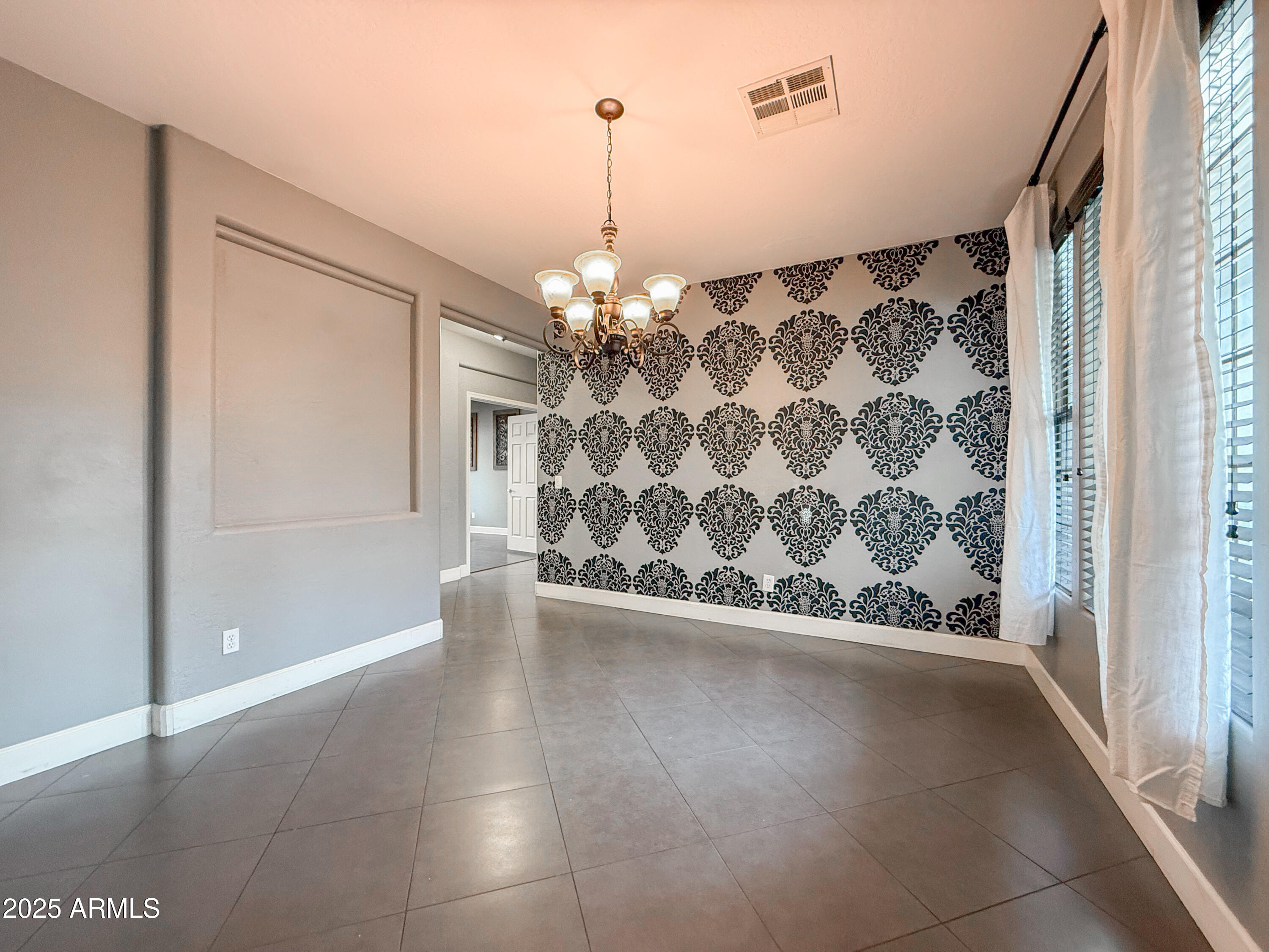 19716 East Thornton Road Queen Creek, AZ 85142 - Photo 17 of 62 a view of a livingroom with wooden floor and a chandelier
