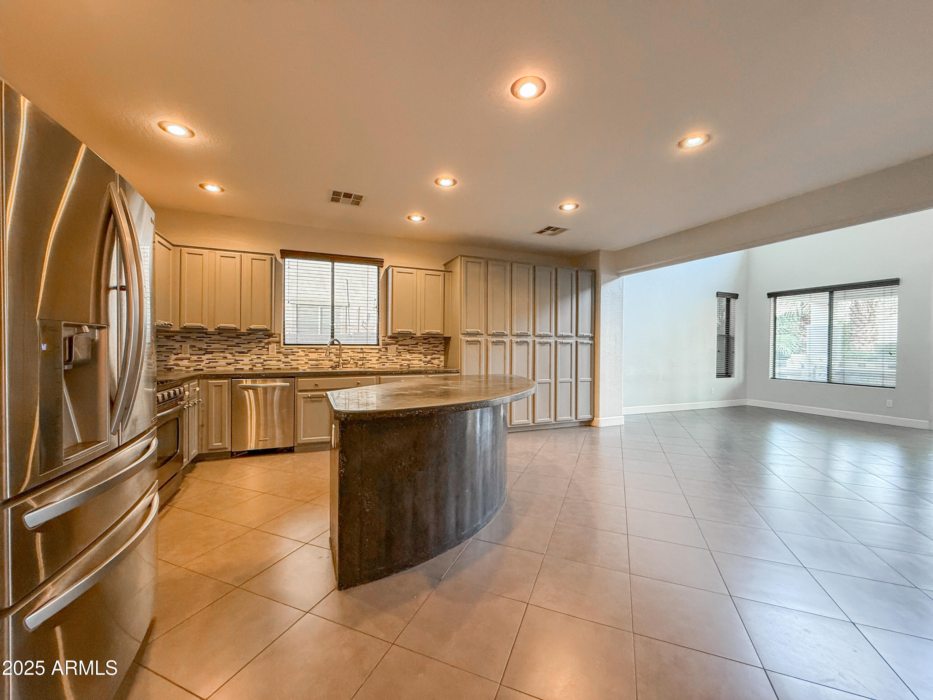 19716 East Thornton Road Queen Creek, AZ 85142 - Photo 18 of 62 a large kitchen with a large counter top stainless steel appliances and cabinets