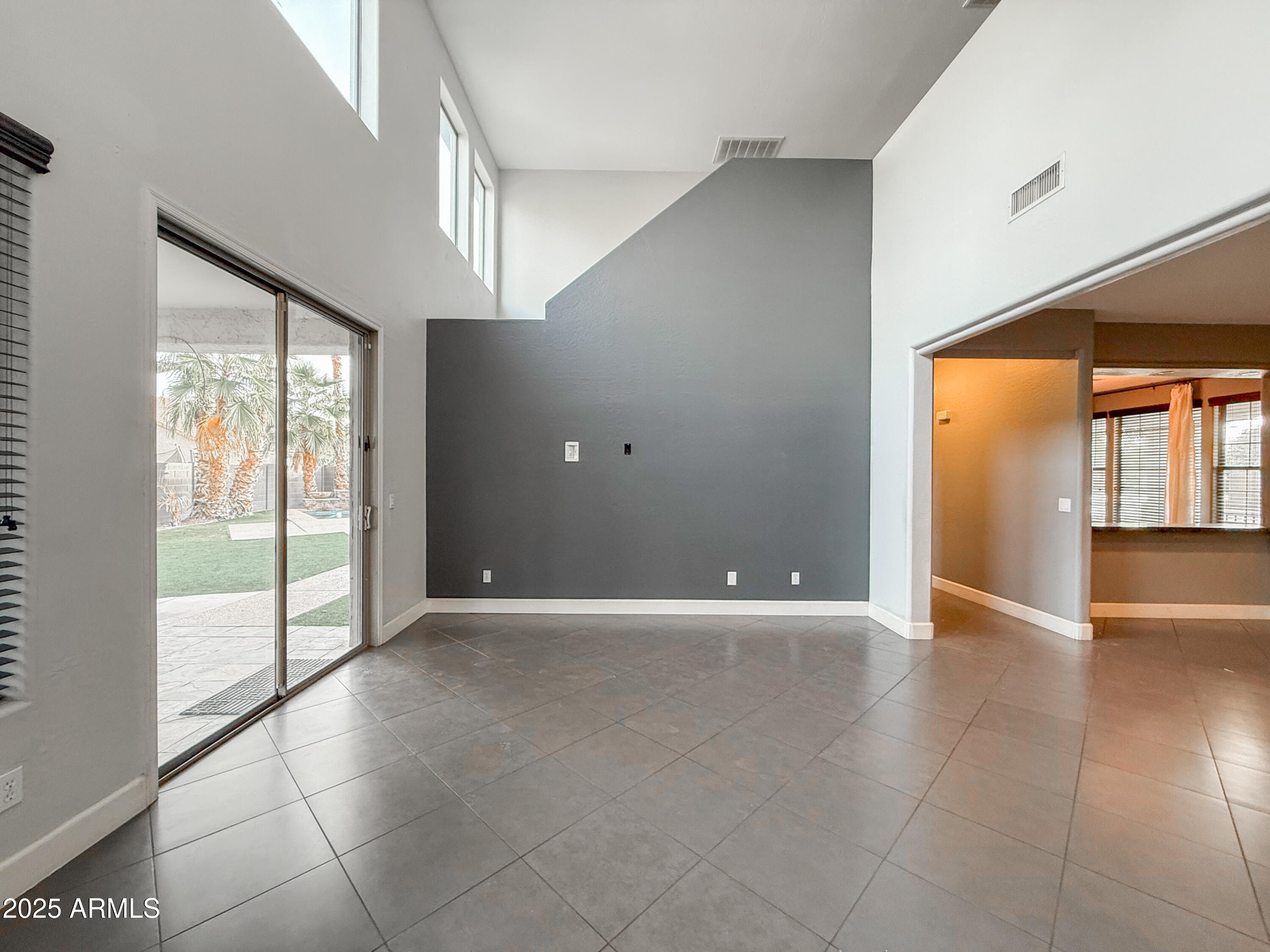 19716 East Thornton Road Queen Creek, AZ 85142 - Photo 26 of 62 a view of an empty room with windows and chandelier