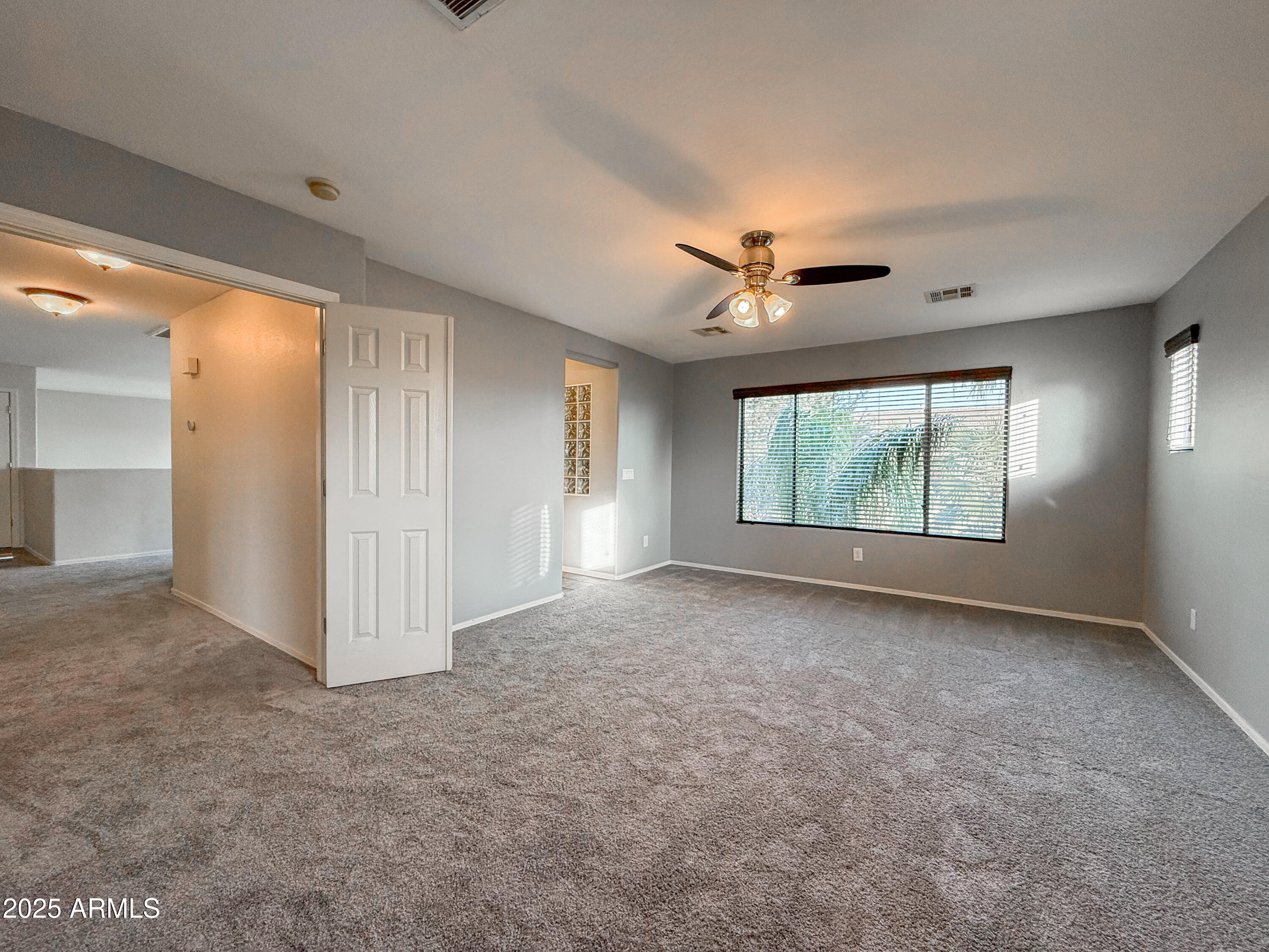 19716 East Thornton Road Queen Creek, AZ 85142 - Photo 34 of 62 an empty room with windows and ceiling fan