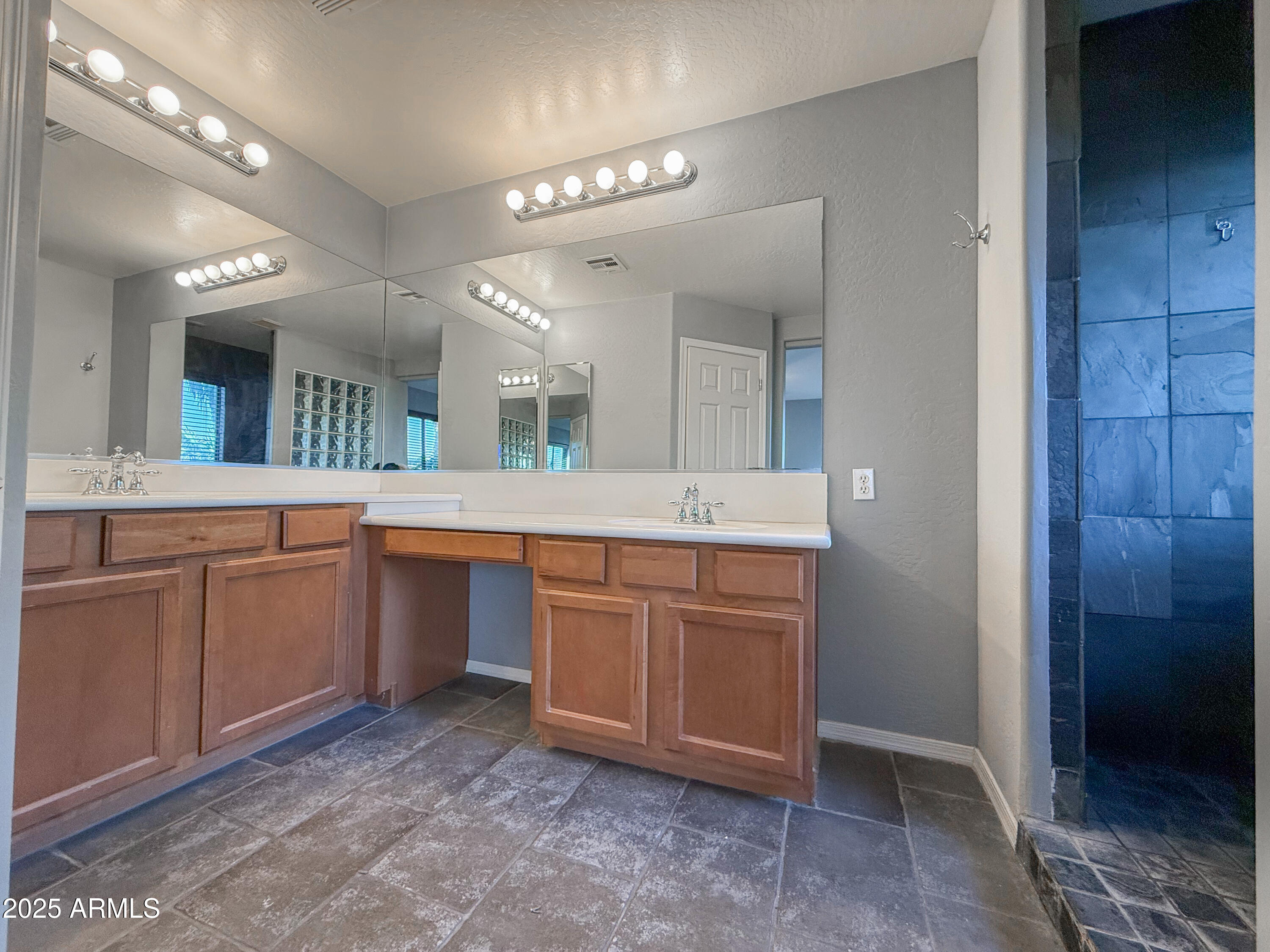 19716 East Thornton Road Queen Creek, AZ 85142 - Photo 38 of 62 a spacious bathroom with a double vanity sink and a mirror