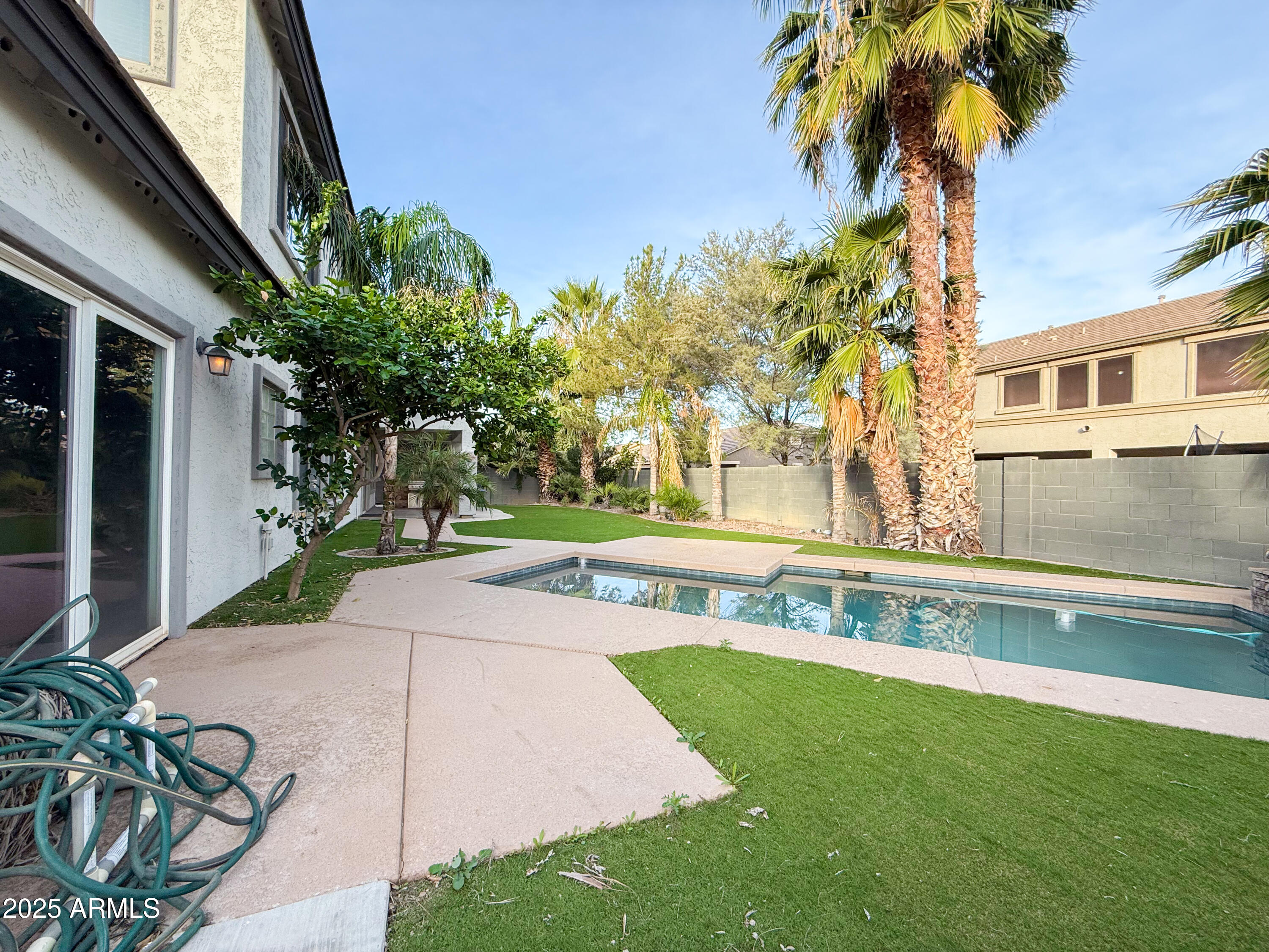19716 East Thornton Road Queen Creek, AZ 85142 - Photo 51 of 62 a view of a house with a swimming pool and a yard