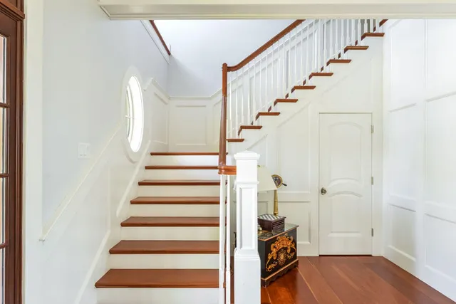 a view of entryway and hall with wooden floor